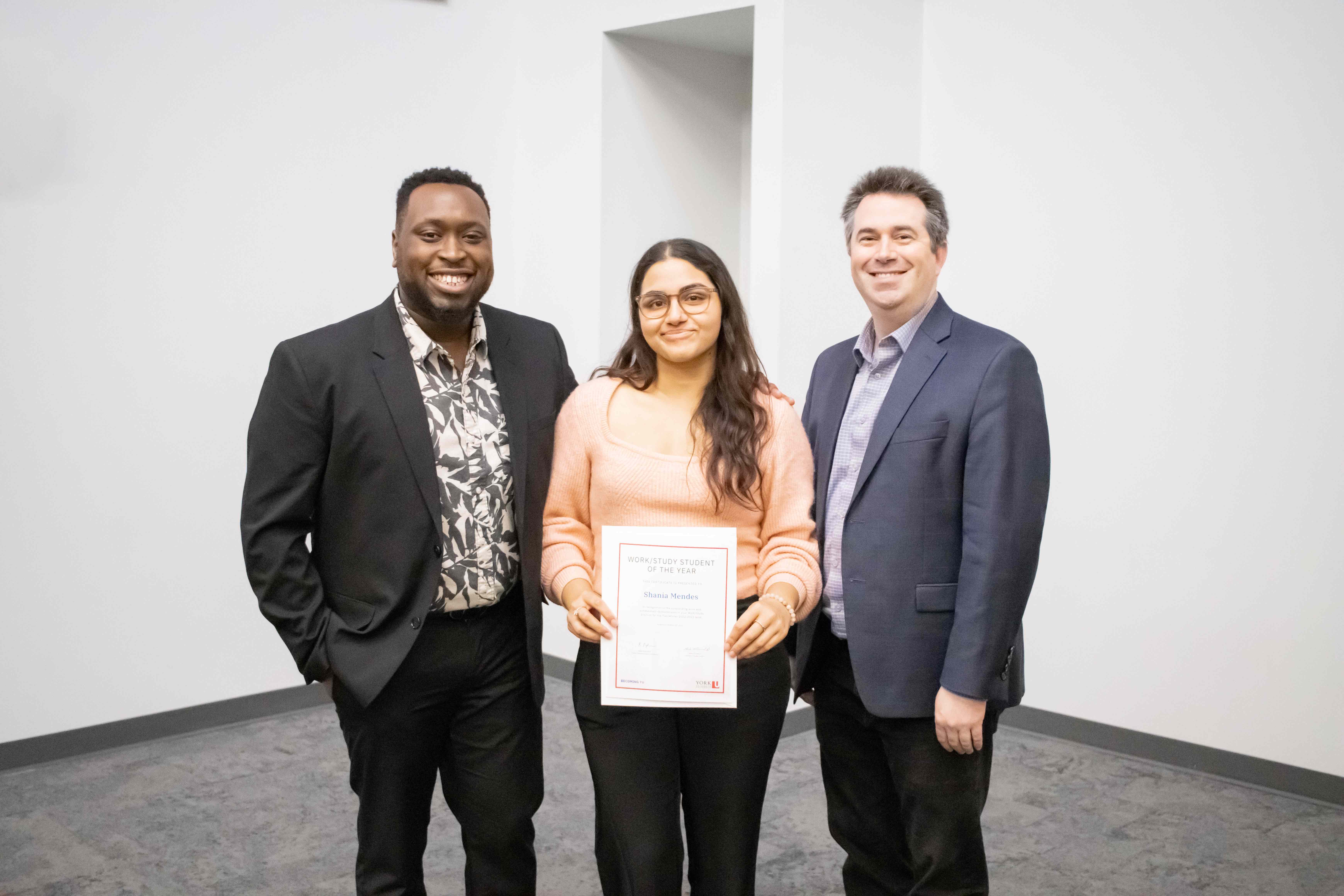 Shania Mendes receiving her award for Becoming YU Student of the Year